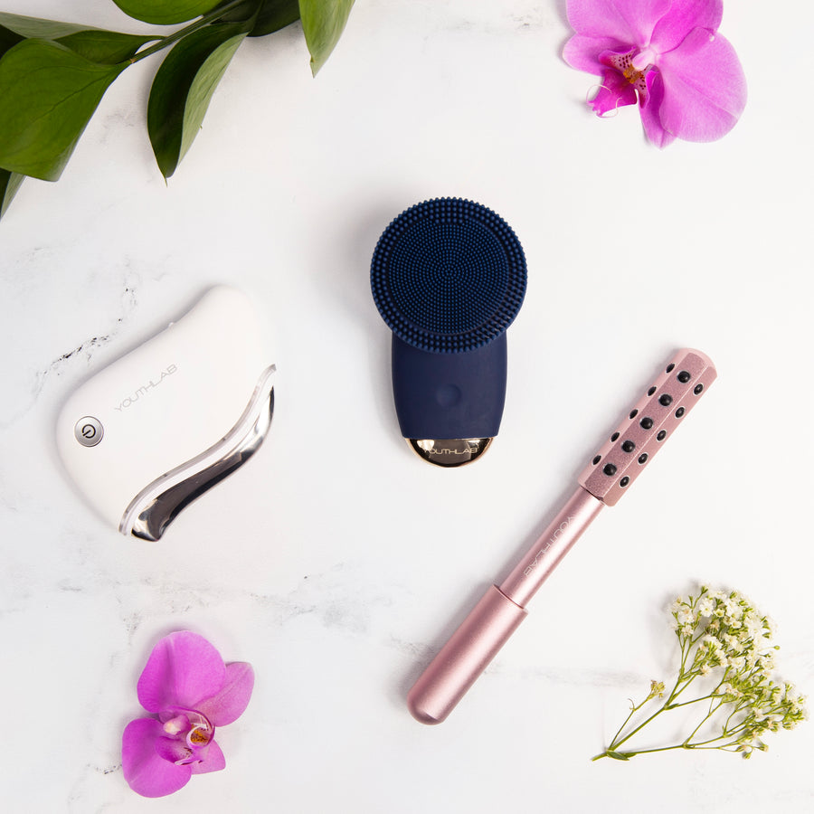YouthLab SoniGlow Silicone Facial Cleansing Brush with Radiance Roller and ProSculpt Gua Sha.